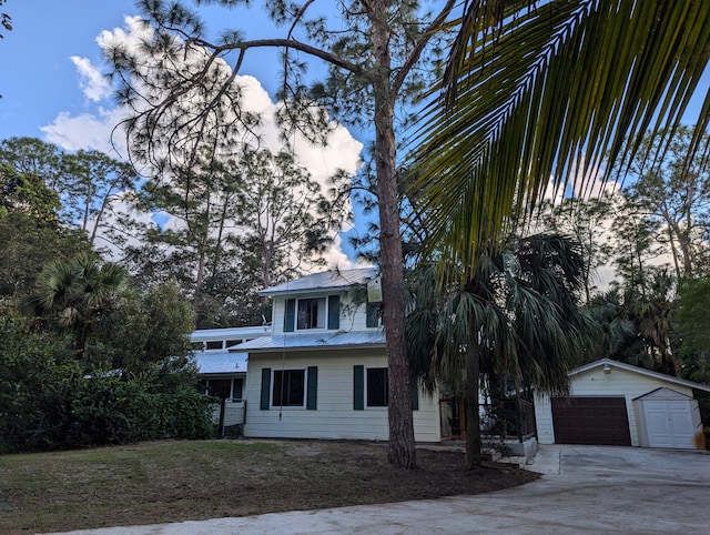 view of front of property featuring a garage and an outbuilding