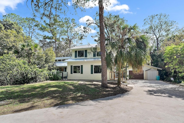 view of front of property featuring a garage and an outdoor structure