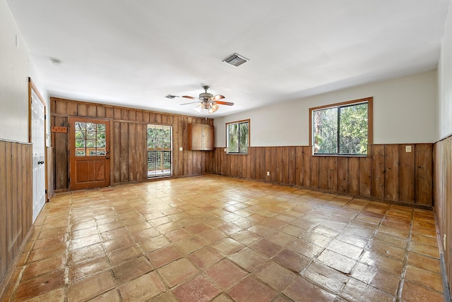 unfurnished room with ceiling fan and plenty of natural light