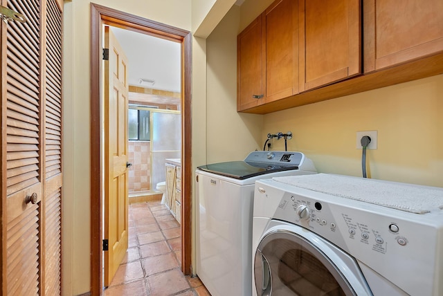 washroom featuring cabinets and washer and dryer