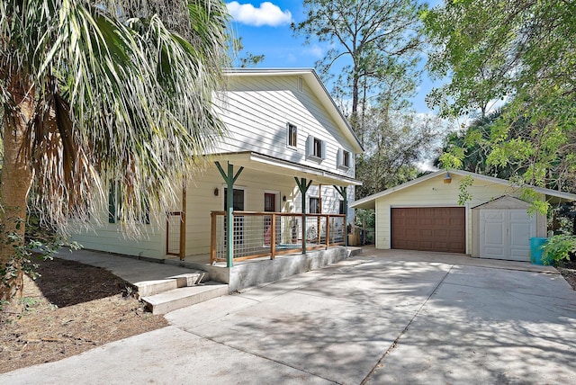 view of front facade with a garage, an outdoor structure, and a porch