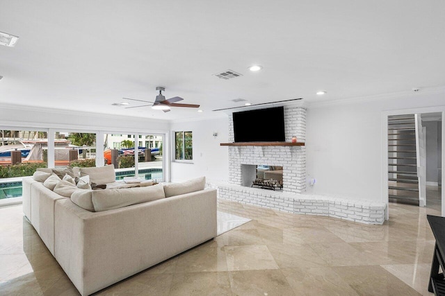 tiled living room with a brick fireplace, ceiling fan, and crown molding