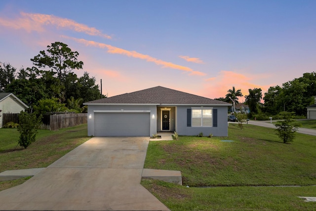 view of front of home featuring a lawn and a garage