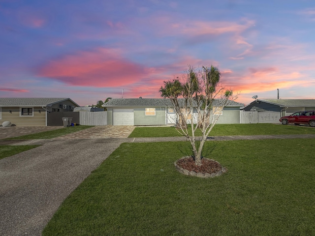 view of front of property featuring a lawn and a garage