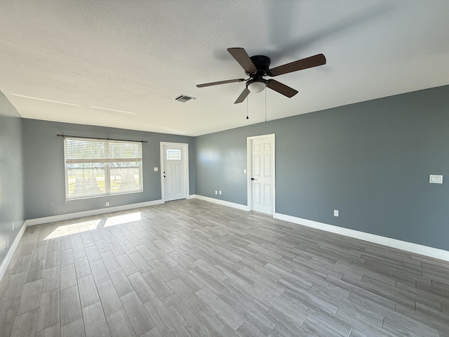 empty room with light hardwood / wood-style floors and ceiling fan