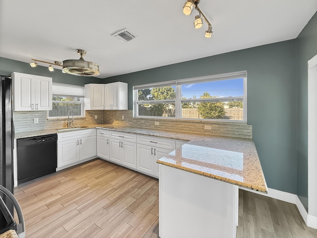 kitchen with sink, black dishwasher, white cabinetry, and kitchen peninsula