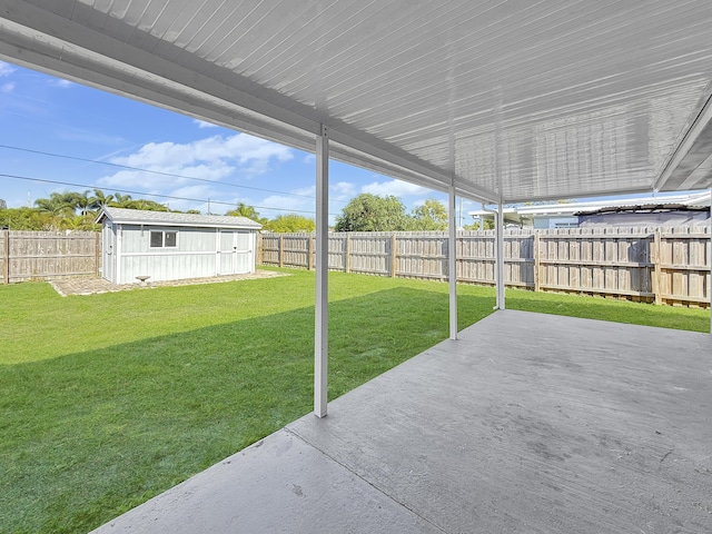 view of yard with a patio area and a storage unit