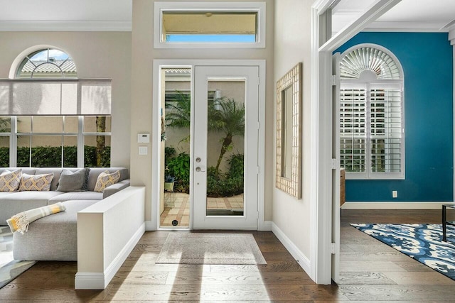 entryway with hardwood / wood-style floors and crown molding