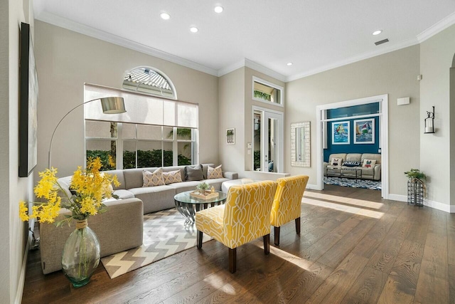 living room with ornamental molding and hardwood / wood-style flooring