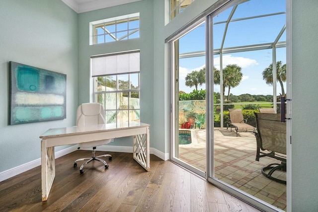 office space with dark hardwood / wood-style floors and ornamental molding