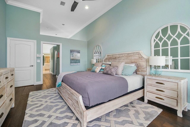 bedroom with ceiling fan, dark wood-type flooring, crown molding, and connected bathroom