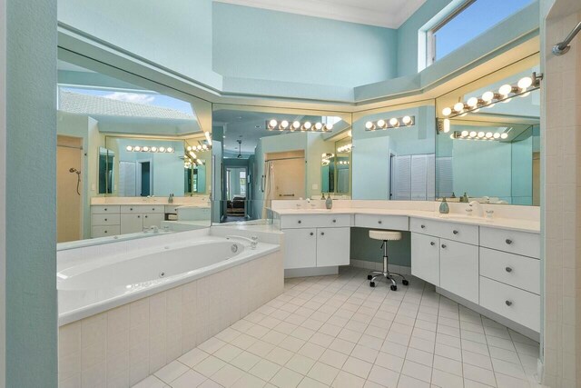 bathroom featuring a towering ceiling, tile patterned floors, separate shower and tub, and vanity