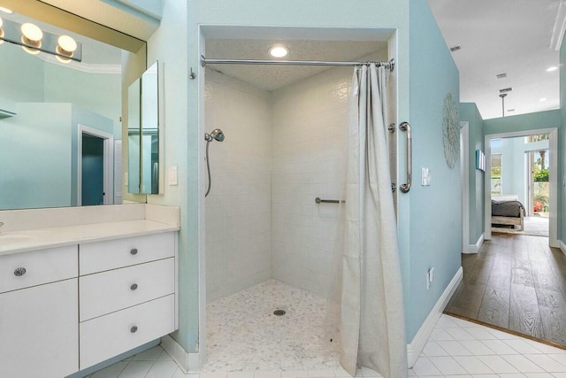 bathroom with tile patterned flooring, vanity, and curtained shower