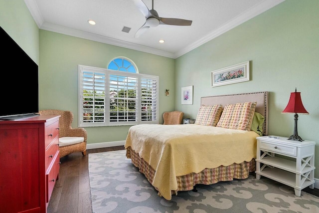 bedroom featuring ceiling fan, ornamental molding, and hardwood / wood-style floors