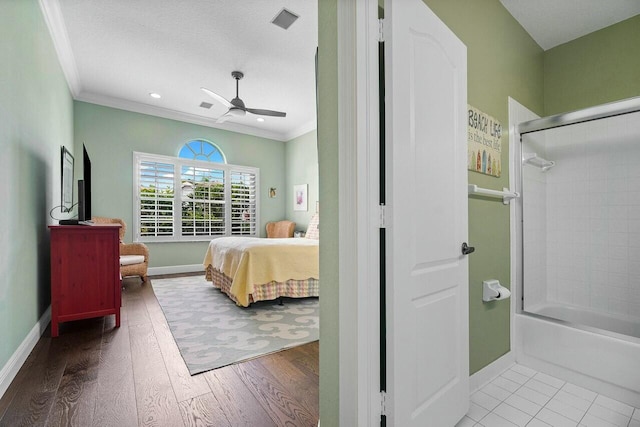 bedroom featuring ceiling fan, ornamental molding, and light hardwood / wood-style floors