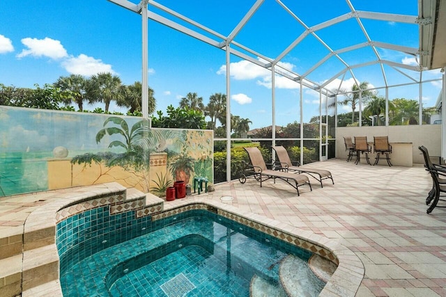 view of swimming pool featuring a hot tub, a patio, and glass enclosure