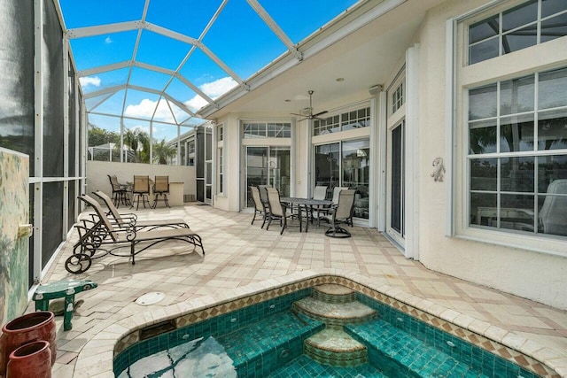 view of pool featuring ceiling fan, a lanai, and a patio area