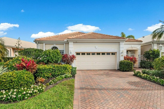 mediterranean / spanish-style house with a garage