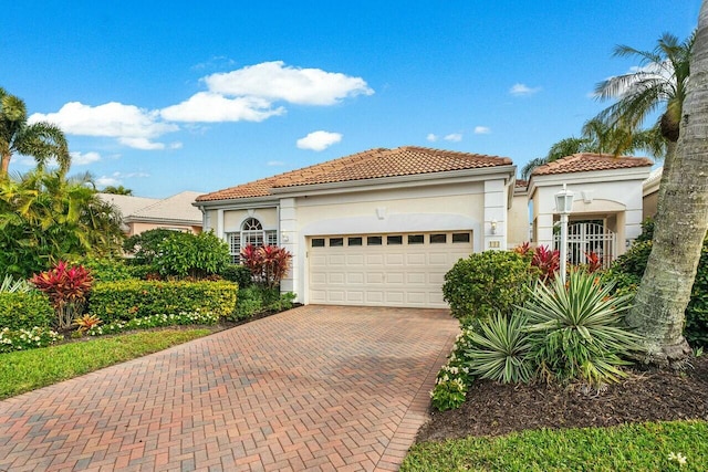 mediterranean / spanish-style home with a garage