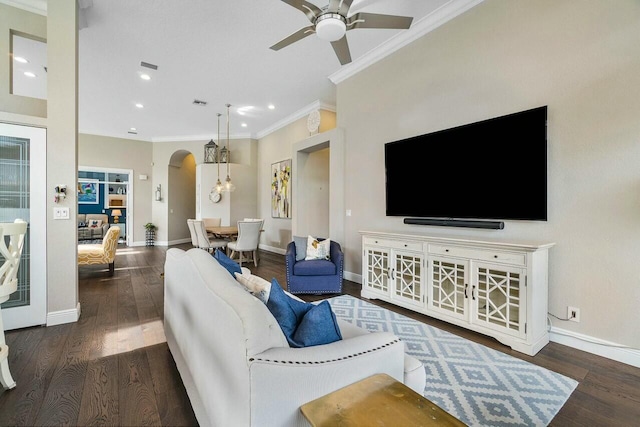 living room featuring ceiling fan, dark hardwood / wood-style flooring, and crown molding