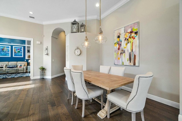 dining space featuring dark hardwood / wood-style flooring and crown molding