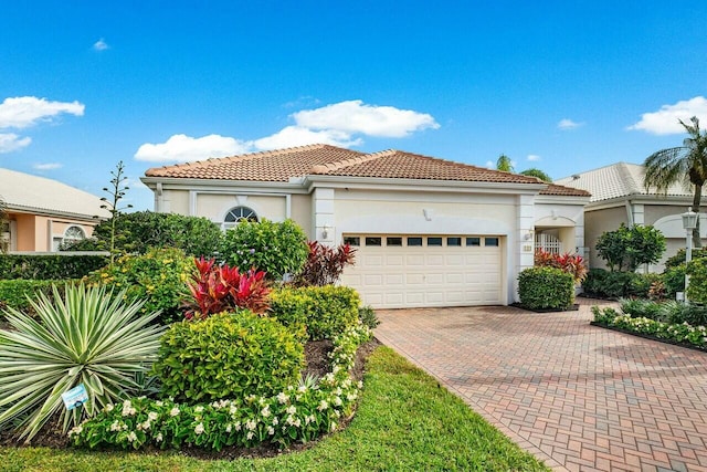 mediterranean / spanish home with a garage