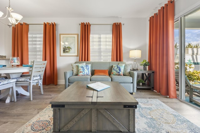 living room featuring light hardwood / wood-style flooring and an inviting chandelier