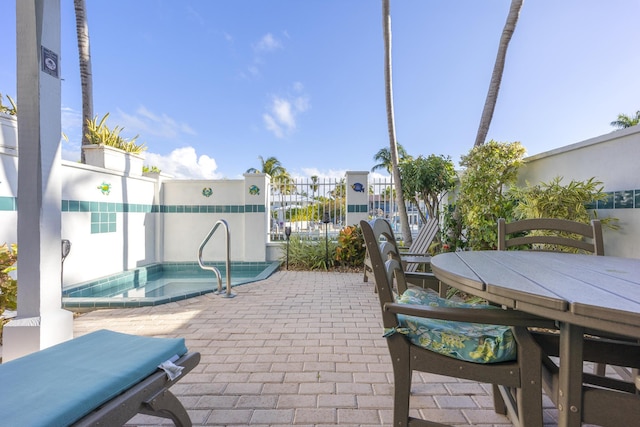 view of patio featuring an in ground hot tub