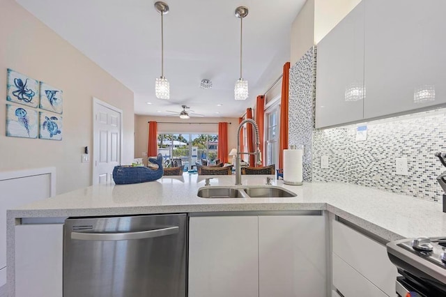 kitchen with ceiling fan, tasteful backsplash, dishwasher, sink, and white cabinetry