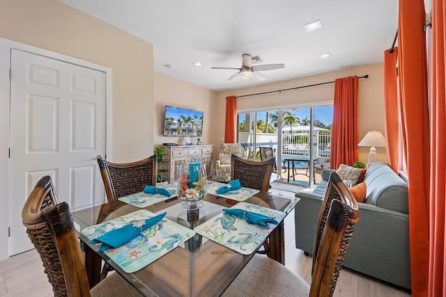 dining space featuring ceiling fan and light wood-type flooring