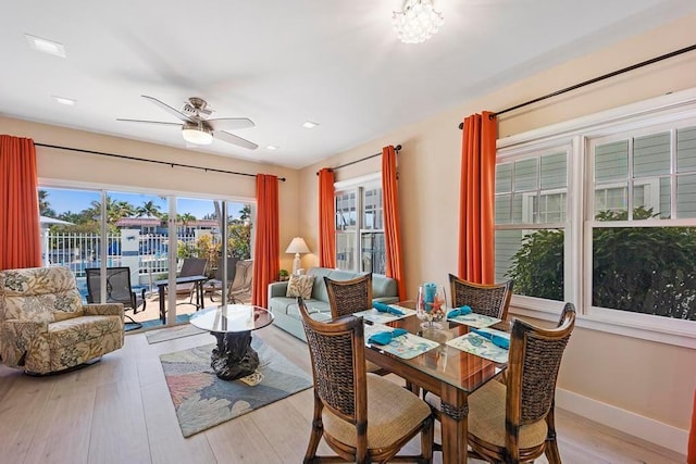 dining room with light wood-type flooring and ceiling fan