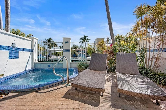 view of pool with an in ground hot tub