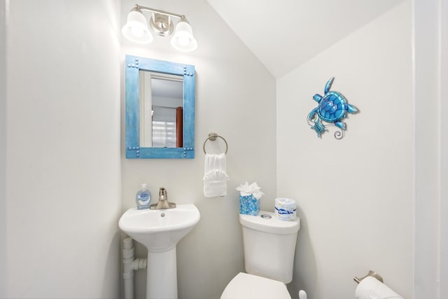 bathroom featuring lofted ceiling and toilet