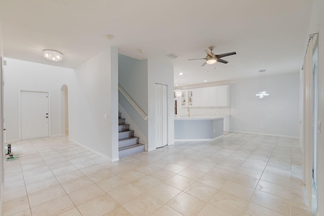 interior space featuring ceiling fan and light tile patterned floors