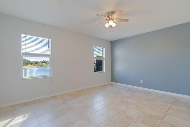 spare room featuring ceiling fan and light tile patterned flooring