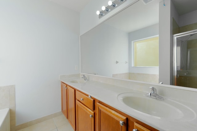 bathroom featuring tile patterned flooring, shower with separate bathtub, and vanity