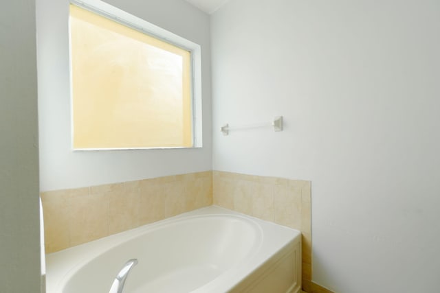 bathroom featuring a bathtub and plenty of natural light