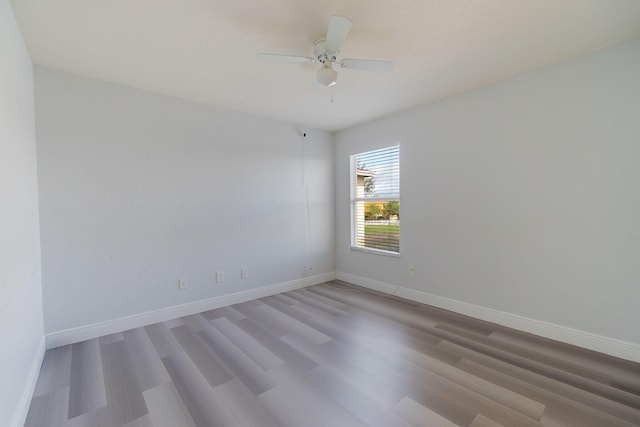 unfurnished room with light wood-type flooring and ceiling fan