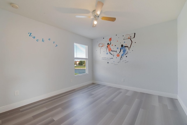 empty room featuring ceiling fan and hardwood / wood-style floors