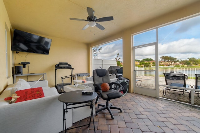 exterior space with a water view and ceiling fan