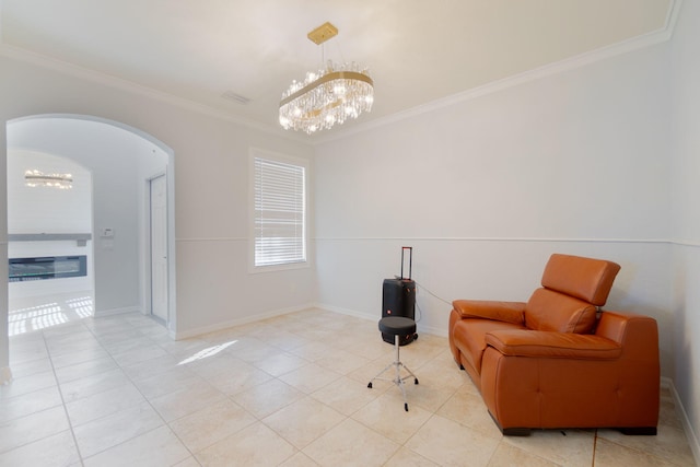 sitting room featuring light tile patterned floors, a chandelier, and crown molding