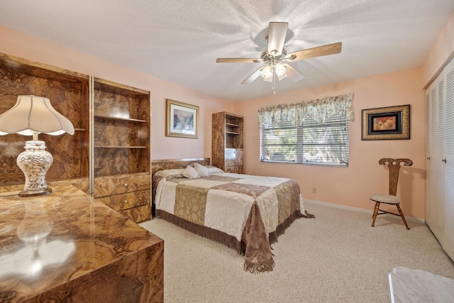 bedroom with a textured ceiling, ceiling fan, and a closet