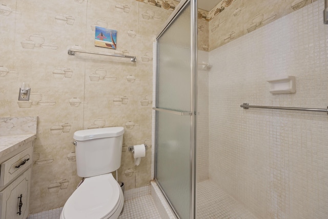 bathroom featuring toilet, vanity, and a shower with shower door