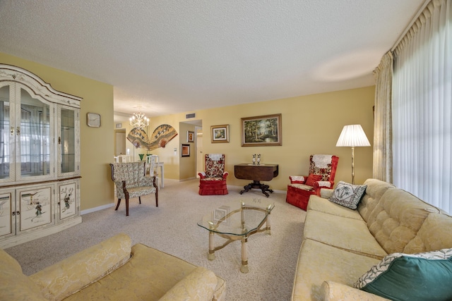 living room with carpet floors, a textured ceiling, and a notable chandelier