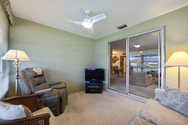 living room featuring carpet floors and ceiling fan