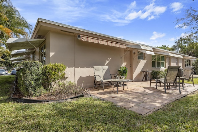 rear view of house featuring a lawn