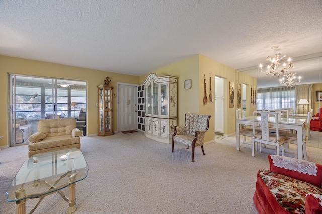 carpeted living room with a notable chandelier and a textured ceiling