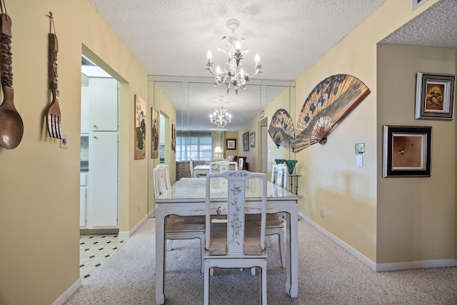 carpeted dining area with a textured ceiling and a chandelier