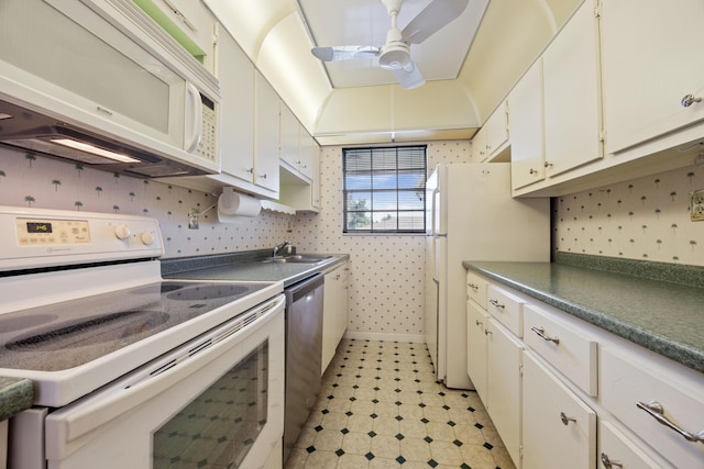 kitchen with white cabinetry, sink, white appliances, and ceiling fan