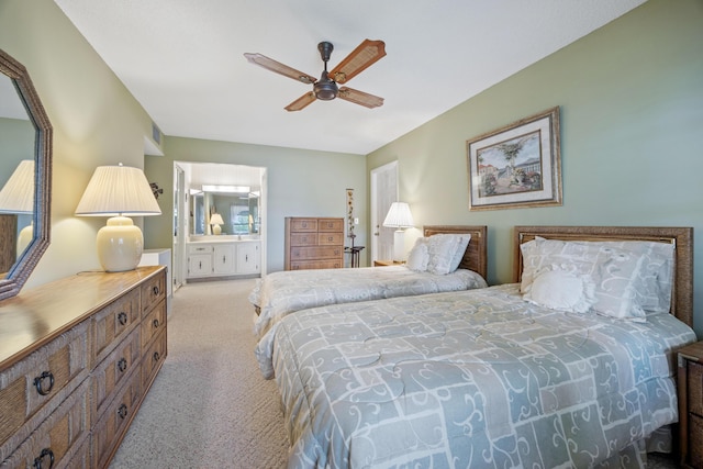 bedroom featuring ceiling fan, light colored carpet, and ensuite bathroom